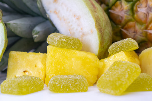 Colorful 1:1 gummies and fresh tropical fruits showcasing Balance for a healthy lifestyle.