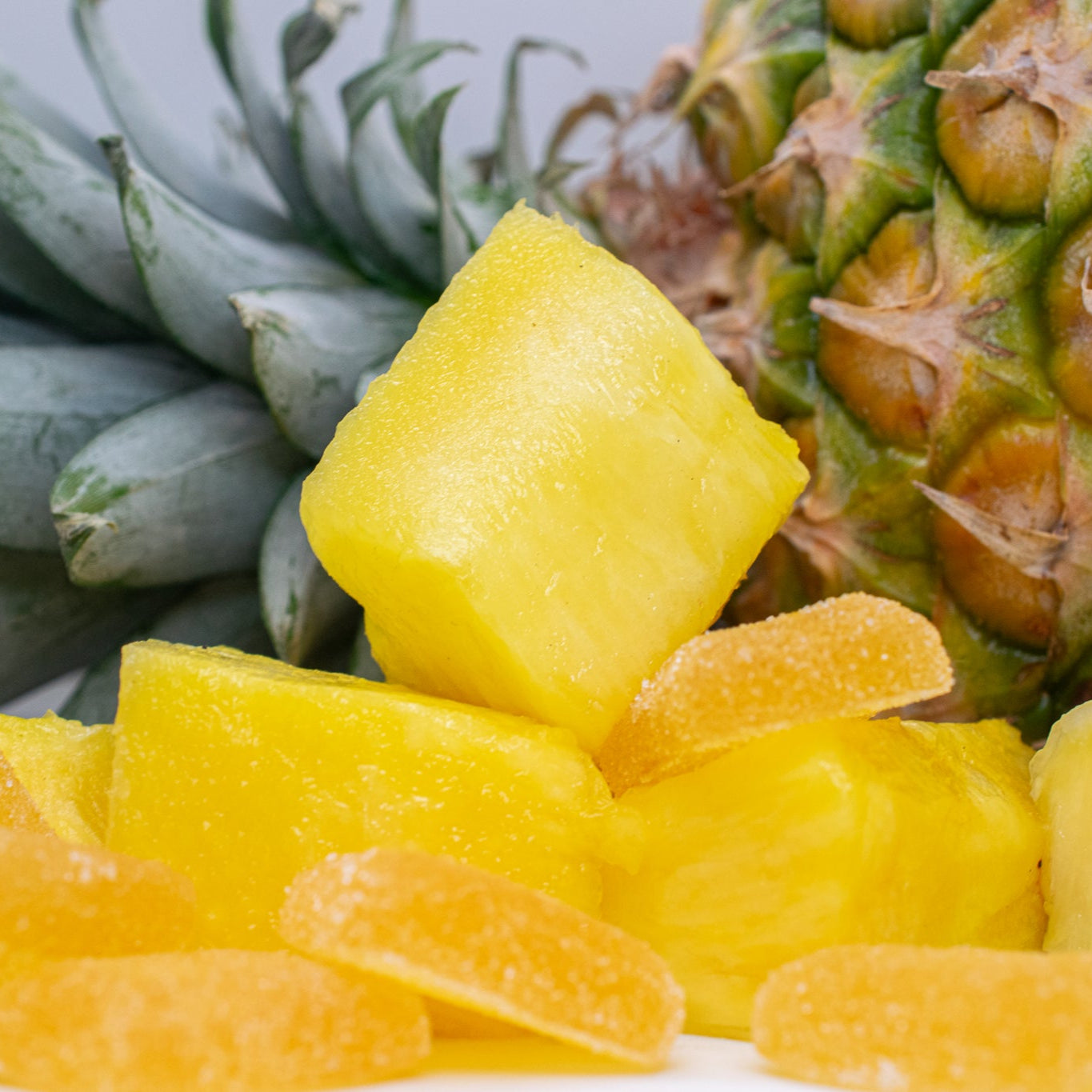 Balance 1:1 THC CBD Gummies with pineapple and gummy candies, showcasing the entourage effect.
