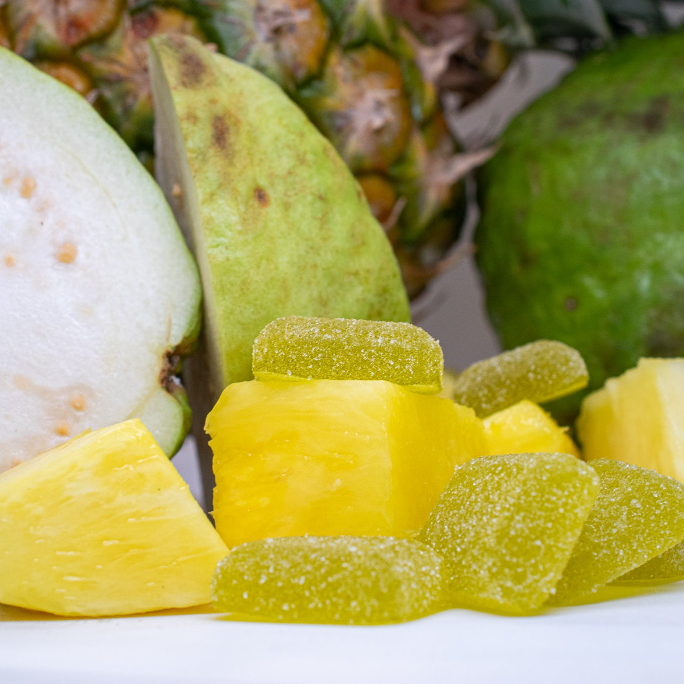 Balance 1:1 THC:CBD Gummies in pineapple flavor with fresh pineapple fruit.