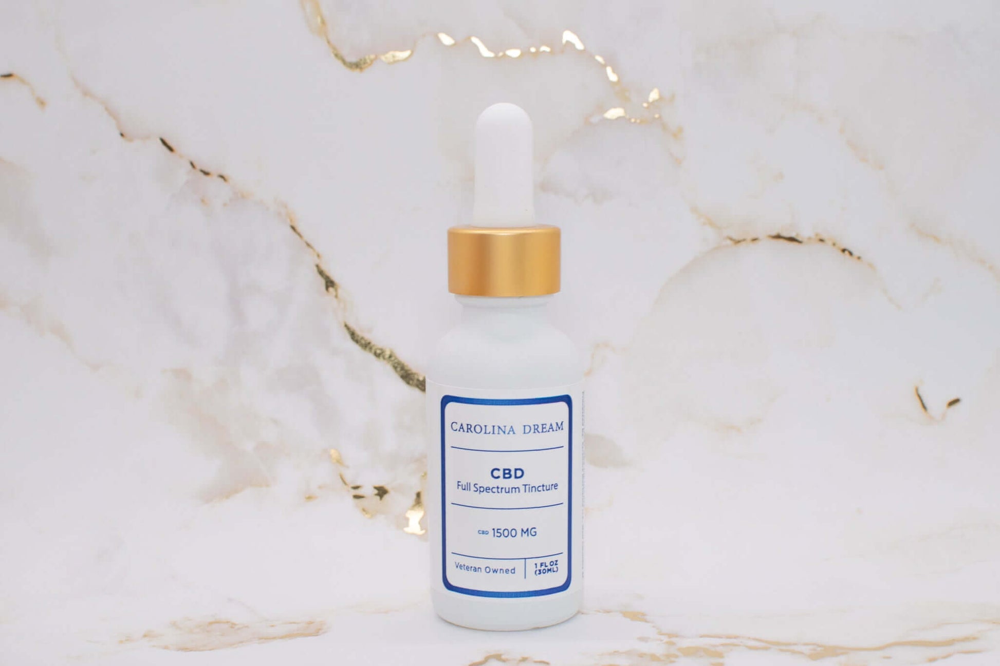Full Spectrum 1500mg CBD Tincture bottle with dropper on marble background.