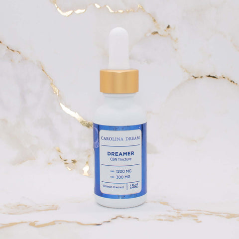 Dreamer Nighttime Tincture bottle featuring 1200mg CBD and 300mg CBN on a marble background.